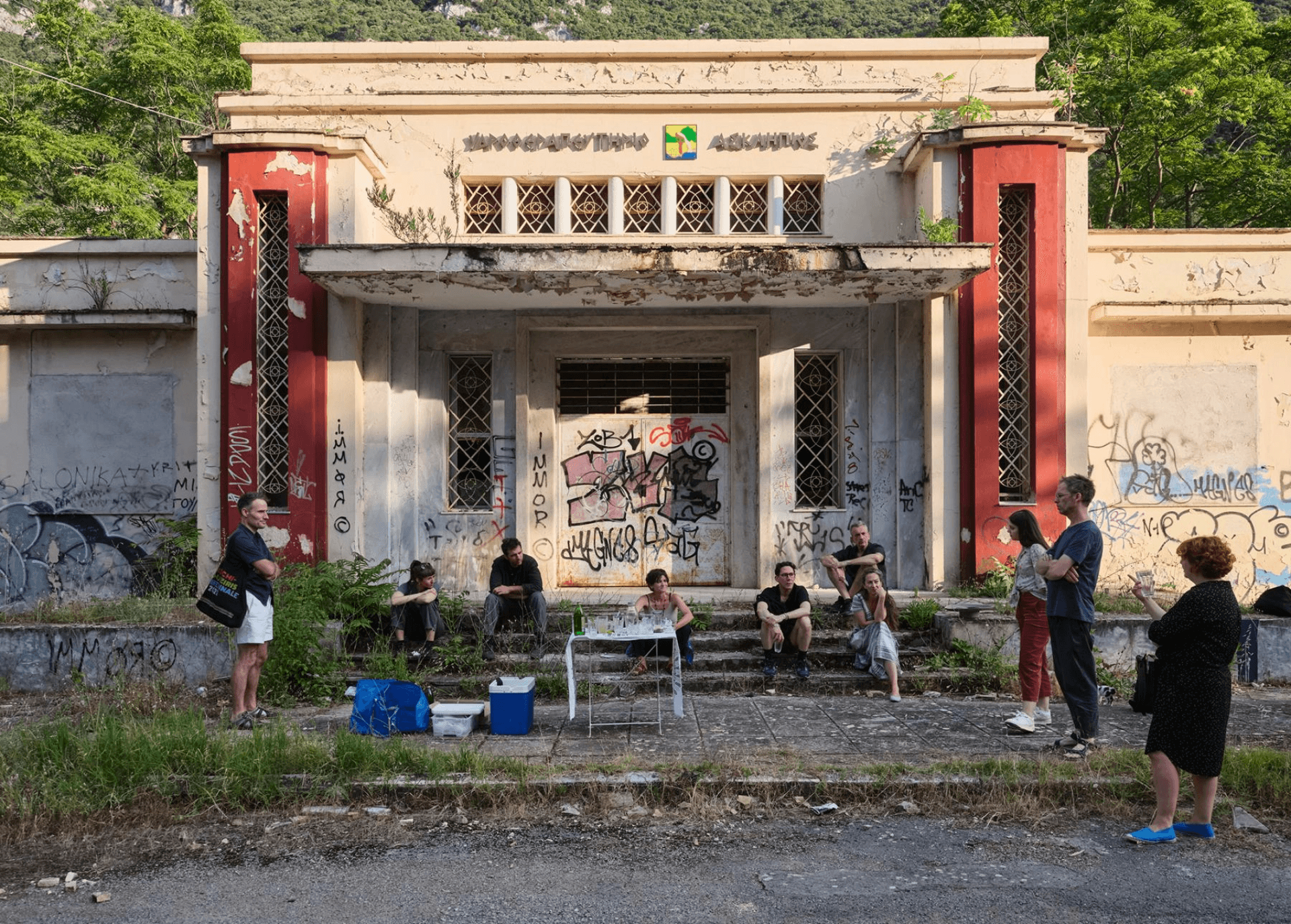Friends gathered outside the Asclepius Hydrotherapy Bath building which opened its doors in 1938, by the architect Gerasimos Molfesis.
